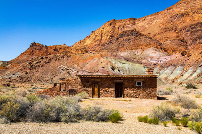 Scenic view of mountains against clear blue sky