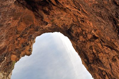 Low angle view of rock formation against sky