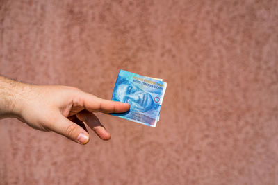 Cropped hand holding paper currency