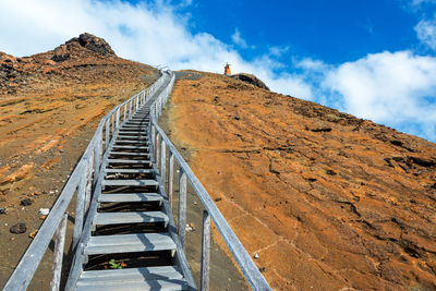 Low angle view of steps on mountain against sky at bartolome island