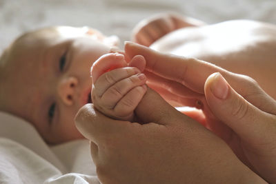 Baby hand in mother hands. newborn baby tiny fingers, close up. maternity, family, birth. infant. 