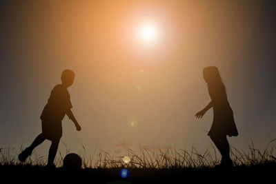 Silhouette of playing at sunset