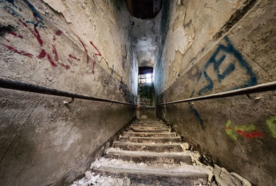 Low angle view of steps amidst buildings