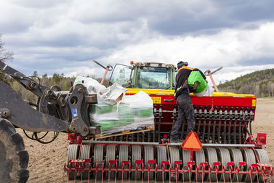 Farm machine working in plowed field