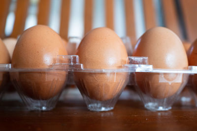 Close-up of eggs in carton on table