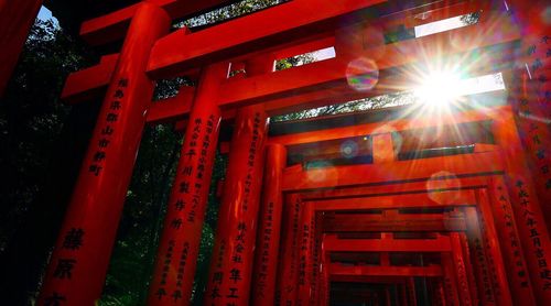 Low angle view of religious script on orange pillars