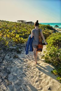 Rear view of woman walking on beach