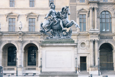 Statue in front of building