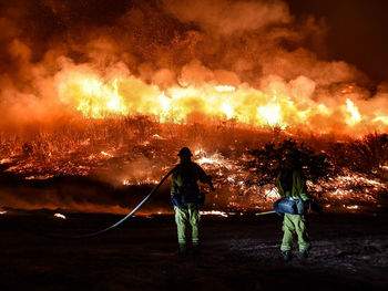 Rear view of people with fire