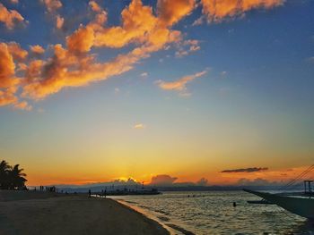 Scenic view of beach against sky during sunset