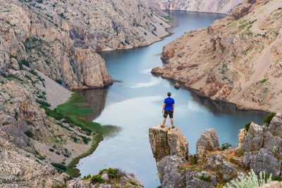 Man looking at view of rock formation