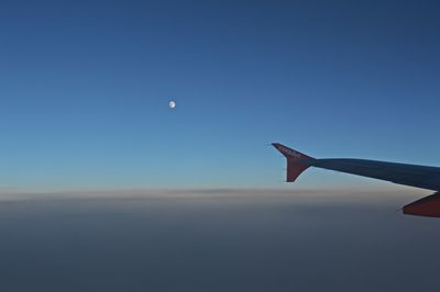 Airplane flying against clear blue sky