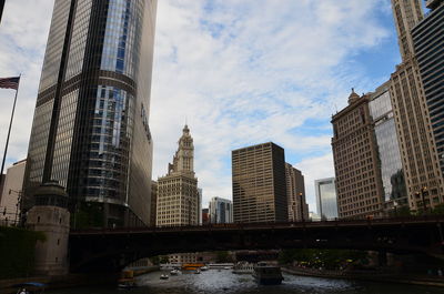 Low angle view of buildings against cloudy sky