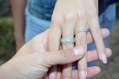 Midsection of couple holding hands