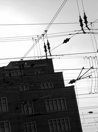 Low angle view of electricity pylon against sky