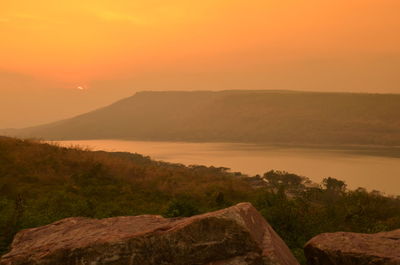 Scenic view of lake at sunset