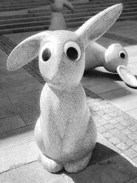 Close-up of stuffed toy on footpath