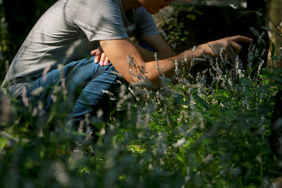 Midsection of man by plants