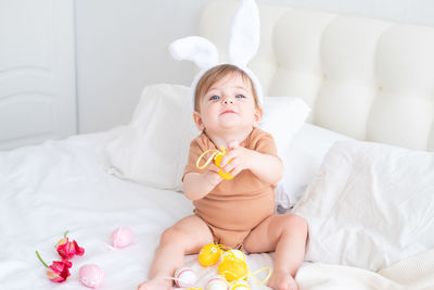 Portrait of cute baby boy sleeping on bed at home