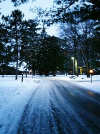 Road passing through snow covered landscape