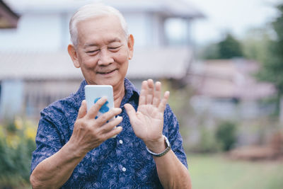 Mid adult man using mobile phone