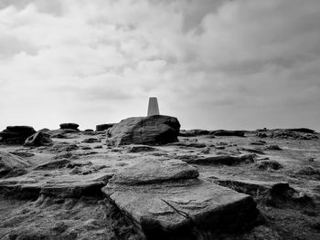 Rocks on beach against sky