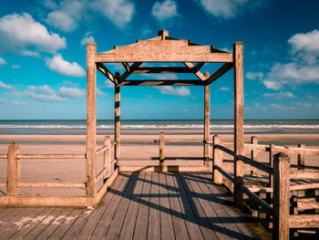 View of wooden structure on beach against sky
