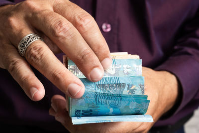 Close-up of hand holding paper