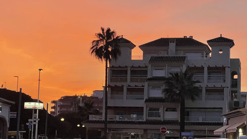 Silhouette buildings against sky during sunset