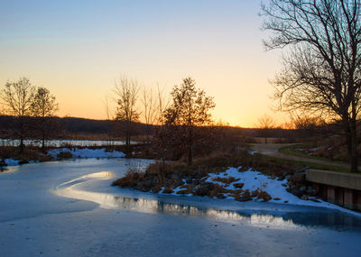 Scenic view of lake against clear sky during winter