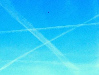 Low angle view of vapor trails in sky