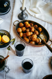 Roasted baby potatoes on a dinner table with serving spoon
