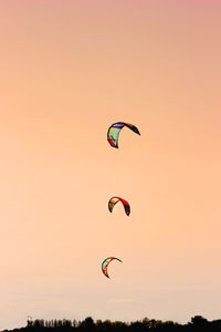 Low angle view of person paragliding against sky