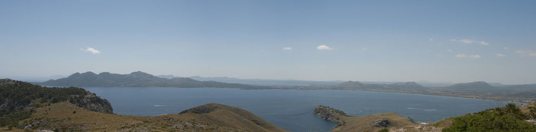 Panoramic view of sea and mountains against sky