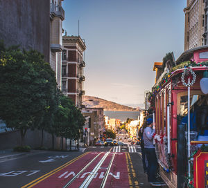 View of city street and buildings against sky