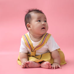 Cute baby girl with pink background