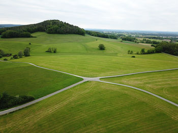 Aerial view of green landscape against sky