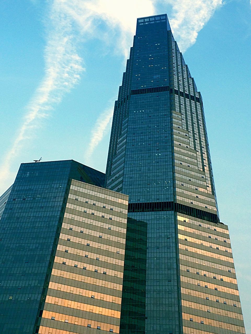 building exterior, architecture, built structure, low angle view, tall - high, sky, city, skyscraper, tower, office building, modern, blue, cloud - sky, building, tall, day, outdoors, reflection, no people, cloud