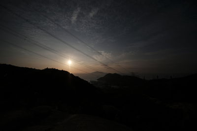 Scenic view of silhouette mountains against sky during sunset