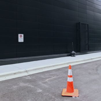 ARROW SYMBOL ON ROAD BY WALL