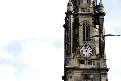 Low angle view of clock tower against sky