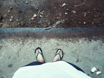 Low section of man standing on footpath