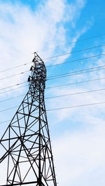 Low angle view of electricity pylon against sky