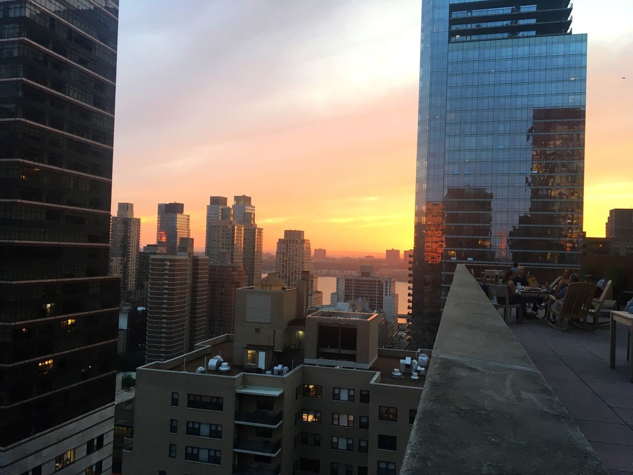 MODERN BUILDINGS AGAINST SKY DURING SUNSET