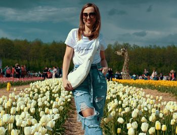 Full length of woman standing against plants