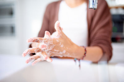 Midsection of man washing hands