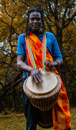 Man playing with umbrella, kenyan man doing traditional dance with drums called masai