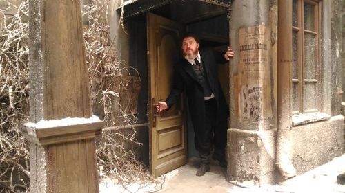 Man standing at entrance of building
