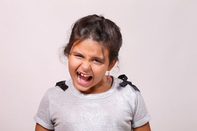 Portrait of smiling boy against white background