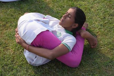 High angle view of woman lying on land